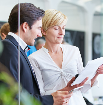 Man and women looking at a report