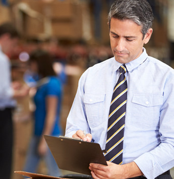 Business man looking at a clipboard
