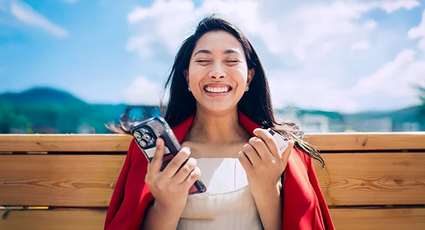 Asian-American woman using Debit Card with Mobile Device