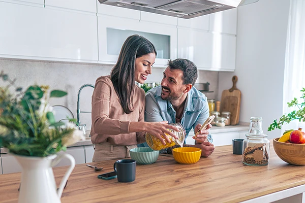 Couple in kitchen using phone